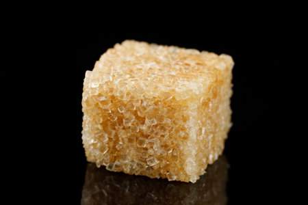 a piece of brown sugar on a black background.の写真素材