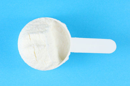 Sports nutrition powder and a measuring spoon.の写真素材
