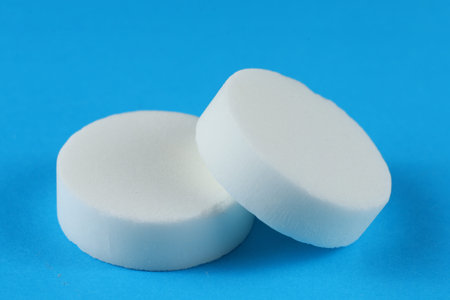 Hexamine fuel tablet on a blue background.の写真素材