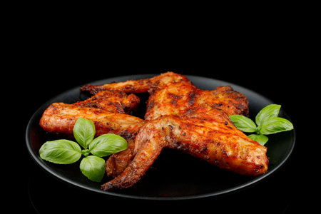 Plate of chicken wings. Fried chicken on a black plate.の写真素材