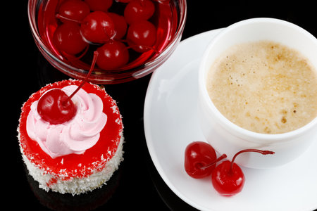 Cake with cream and cherries and coffee with milk. Creamy vanilla cake with cherryの写真素材
