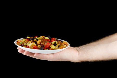 Dried exotic fruits on a plate in hand.の写真素材