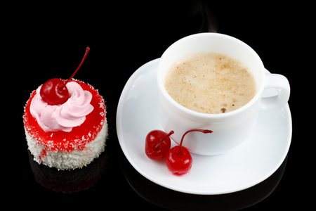 Cake with cream and cherries and coffee with milk.の写真素材