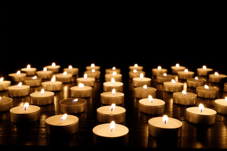 Small candles burning on a dark background. Lights of candlesの写真素材
