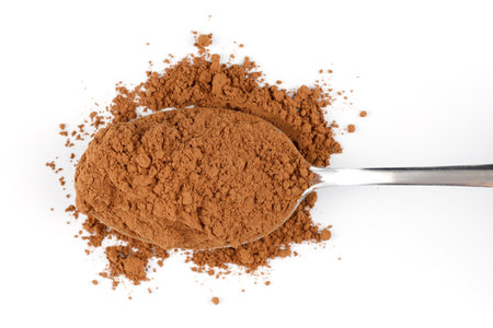 Cocoa powder on a spoon isolateの写真素材
