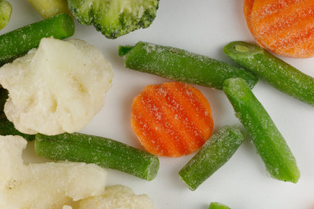 Frozen vegetables close-up on a white background.の写真素材