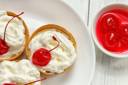 Baskets of pastries with cherry and cream. Close up of sweet cake with fruitsの写真素材