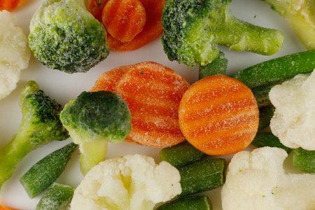 Frozen vegetables close-up on a white background.の写真素材