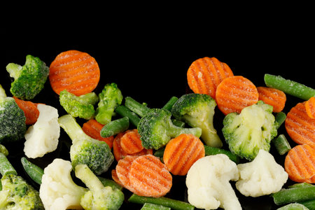 Frozen vegetables close-up on black.の写真素材