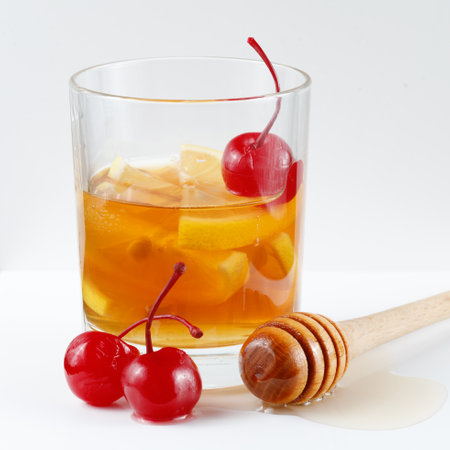 Lemon cocktail with cherry, honey and ice. Fresh colorful exotic alcoholic cocktail with lemon and iceの写真素材