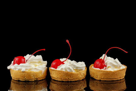 Baskets of pastries with cherry and cream. tartlets with soft cream and cherriesの写真素材