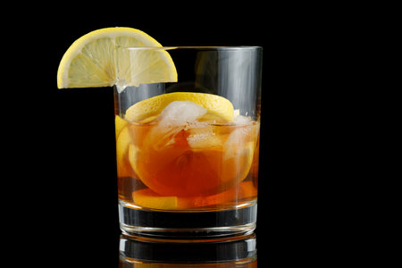 Tea with lemon in a glass. Fresh cold cherry cocktail with ice and lemonの写真素材