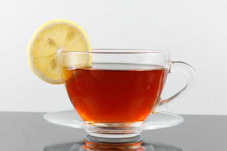 Tea with lemon in a cup. tea in cup with lemon isolated on white backgroundの写真素材