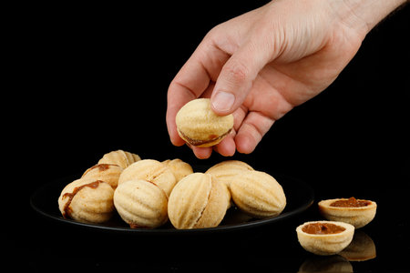 Peanut cookies with condensed milk. Homemade cookies with boiled condensed milk. cookies or cakes in the shape of nuts filled with boiled condensed milkの写真素材