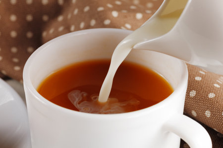 Coffee with milk. Milk is poured into the coffee.の写真素材