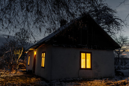 An old clay house in the Ukrainian village. house at night.の写真素材
