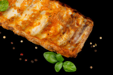 Baked ribs with basil and spices. Rustic vintage wooden table, in a pan of fried juicy pork ribs with meat, spicesの写真素材