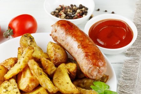 Grilled sausages with spices on a wooden tableの写真素材