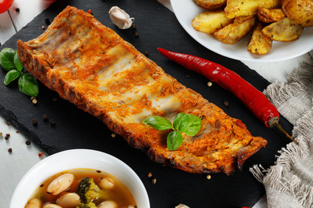 Roasted ribs with herbs and spices. portion of barbecued grilled ribs seasoned with hot spices and fresh herbsの写真素材