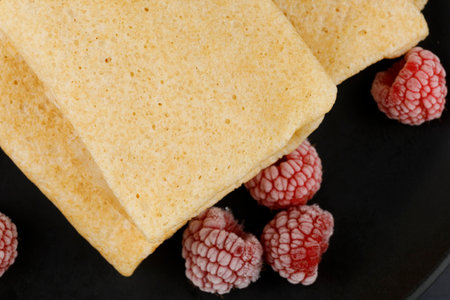 Pancakes with raspberries and nuts on a black plate. homemade pancakes with raspberriesの写真素材