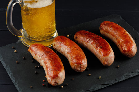 Sausages with beer. Fried anchovies and delicious food with beer.の写真素材