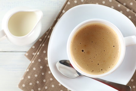 Coffee with milk on the table in the cafeの写真素材