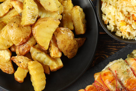 Fried potatoes in a black plate. A dish in a restaurant.の写真素材