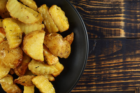 Fried potatoes in a black plate. place for text cope spaceの写真素材