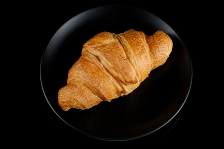Croissant on a black plate. top viewの写真素材