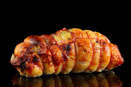 boneless meat roulade isolated on a black backgroundの写真素材
