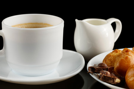 eclairs with chocolate, cappuccino and milk. Sweet breakfast.の写真素材