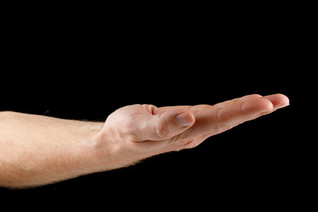 Hand and open palm on black isolate. Caucasian male hand.の写真素材