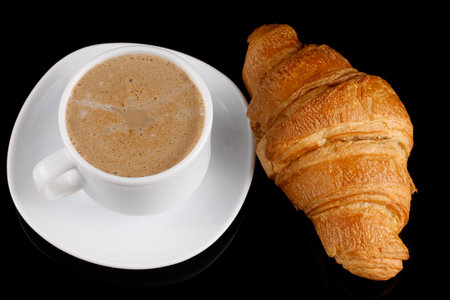 Croissant with cappuccino. Traditional sweet breakfast.の写真素材