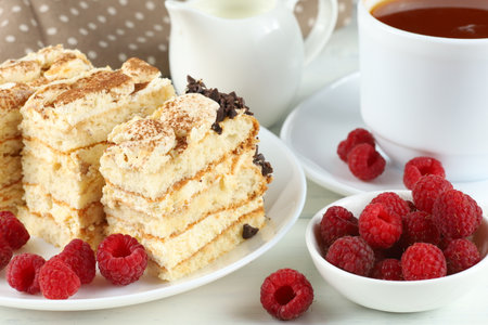 Tiramisu, raspberries and coffee with milk. Chocolate dessert and coffee with milkの写真素材