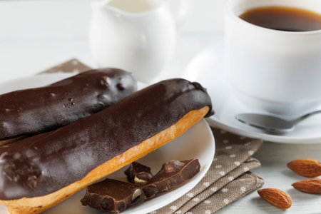Chocolate eclairs in a white plate close-up.の写真素材