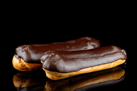 Chocolate eclairs on black isolateの写真素材