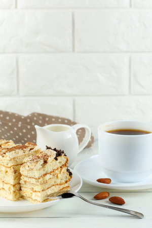 Tiramisu, coffee with milk. Sweet delicious food. Classic tiramisu dessert with cup of coffee and milkの写真素材