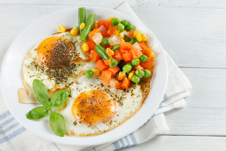 Fried eggs with vegetables. Traditional delicious breakfast and lunch.の写真素材