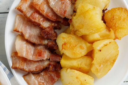 Fried potatoes and bacon. traditional food.の写真素材