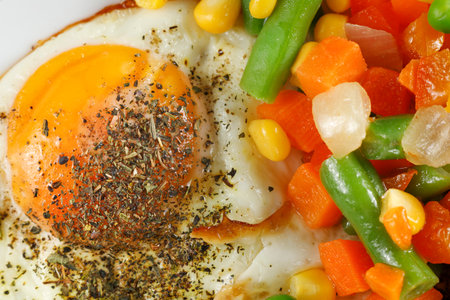 Fried eggs with vegetables. Traditional delicious breakfast and lunch.の写真素材