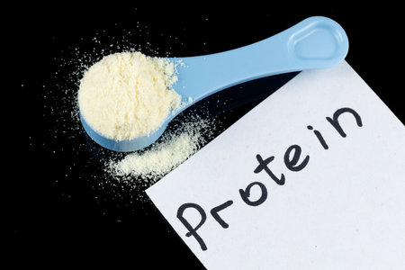 Sports nutrition in a spoon. Wheat protein powder for athletes.の写真素材
