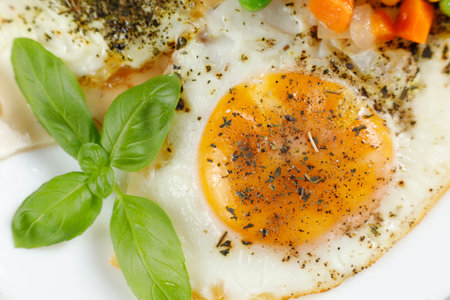 Fried eggs with vegetables. Traditional delicious breakfast and lunch.の写真素材