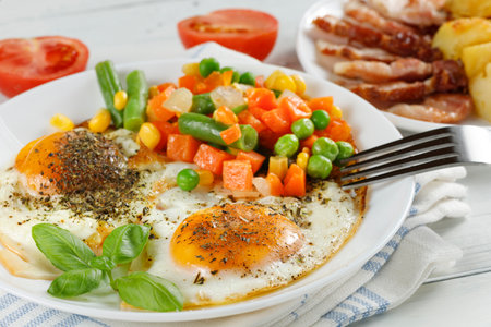 Fried eggs with vegetables. Traditional delicious breakfast and lunch.の写真素材
