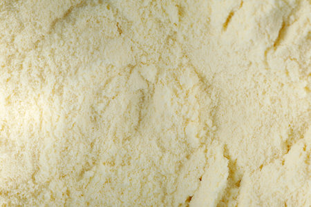 Texture of yellow dry baby food, milk powder. top view. flat layの写真素材