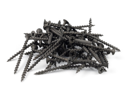 Screws on white. black metal screws pile isolated on the white backgroundの写真素材