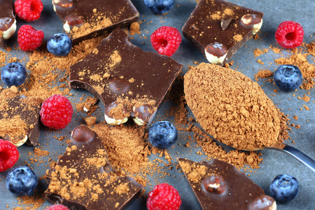 Chocolate with nuts, cocoa and berries. milk chocolate pieces with fruits and nutsの写真素材