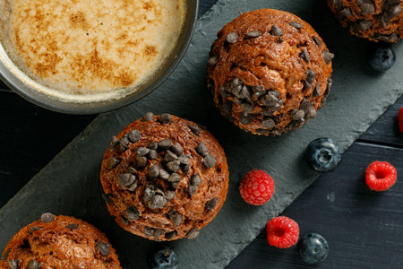 Muffins chocolate cupcakes with cappuccino and berriesの写真素材