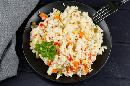 Rice with vegetables in a plate on the table.の写真素材