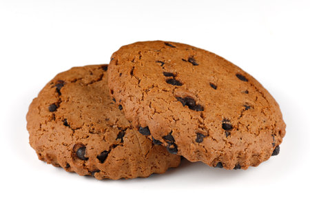 Oatmeal cookies with chocolate pieces on white isolateの写真素材