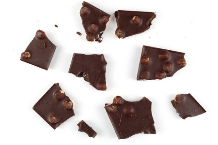 Pieces of chocolate with nuts on whiteの写真素材